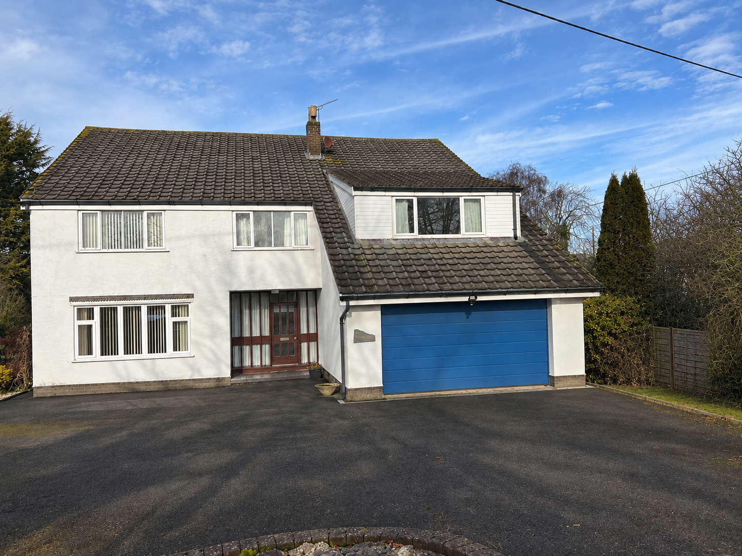 The original six-bedroom family home in Poulton-le-Fylde, Lancashire, before renovation, with a white rendered exterior, pitched roof and front driveway
